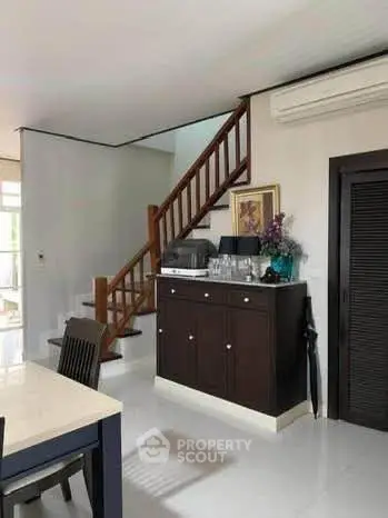 Modern interior with staircase and elegant furniture in a spacious living area.