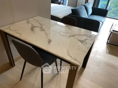 Modern apartment interior with marble table and cozy sofa near window view.