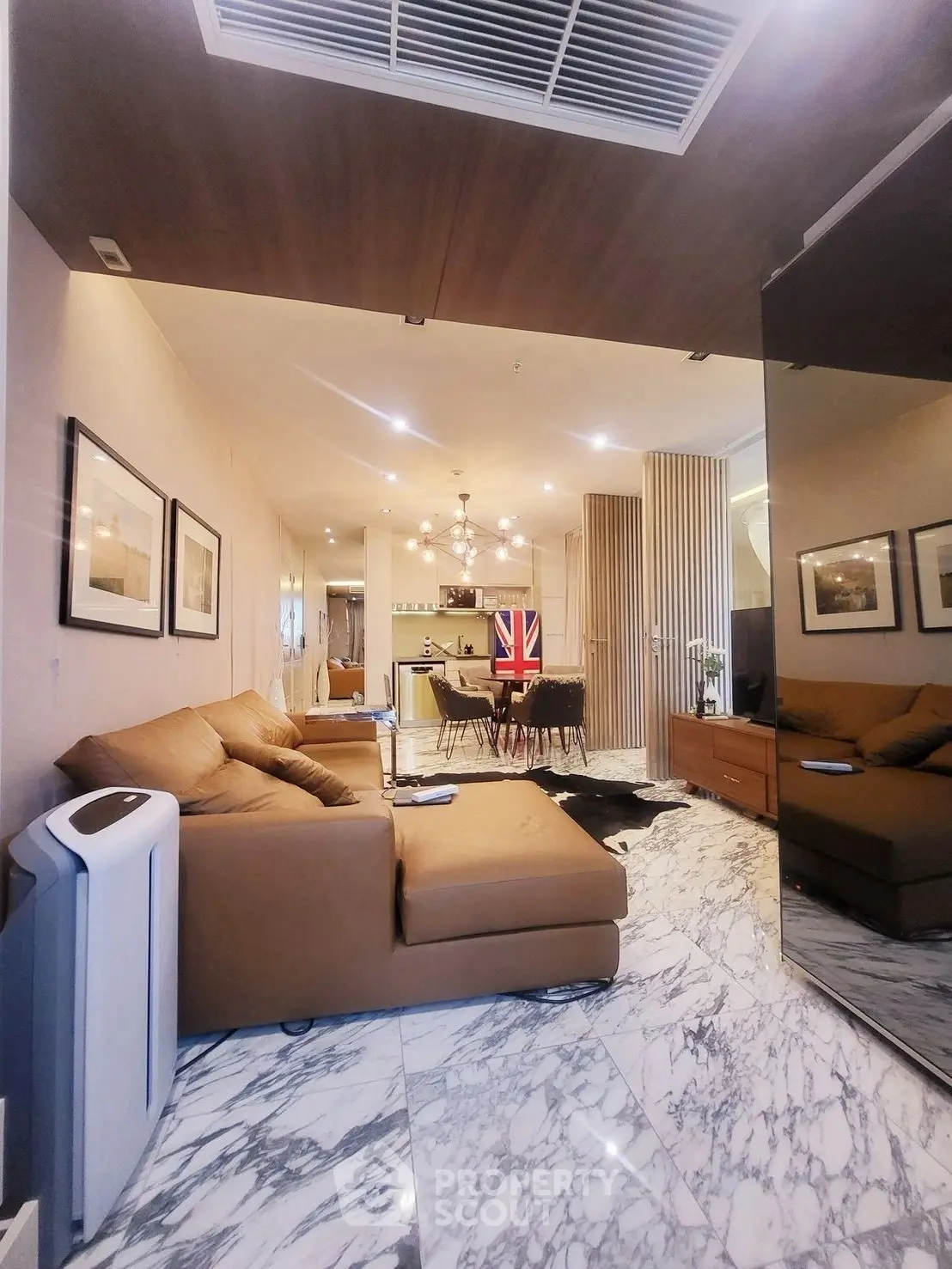 Luxurious living room with marble flooring and modern decor, featuring a cozy seating area and stylish lighting.