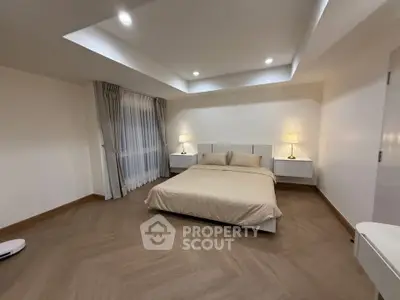 Spacious modern bedroom with elegant lighting and minimalist decor