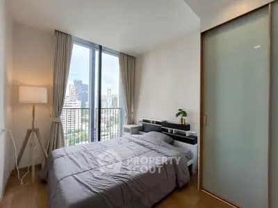 Modern bedroom with city view and stylish decor in high-rise apartment