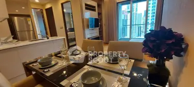 Modern dining area with elegant table setting and city view from balcony in luxury apartment.