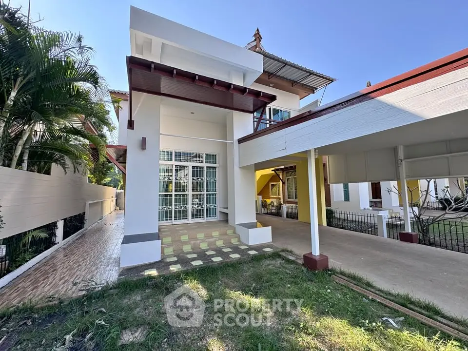 Modern two-story house with spacious carport and lush garden