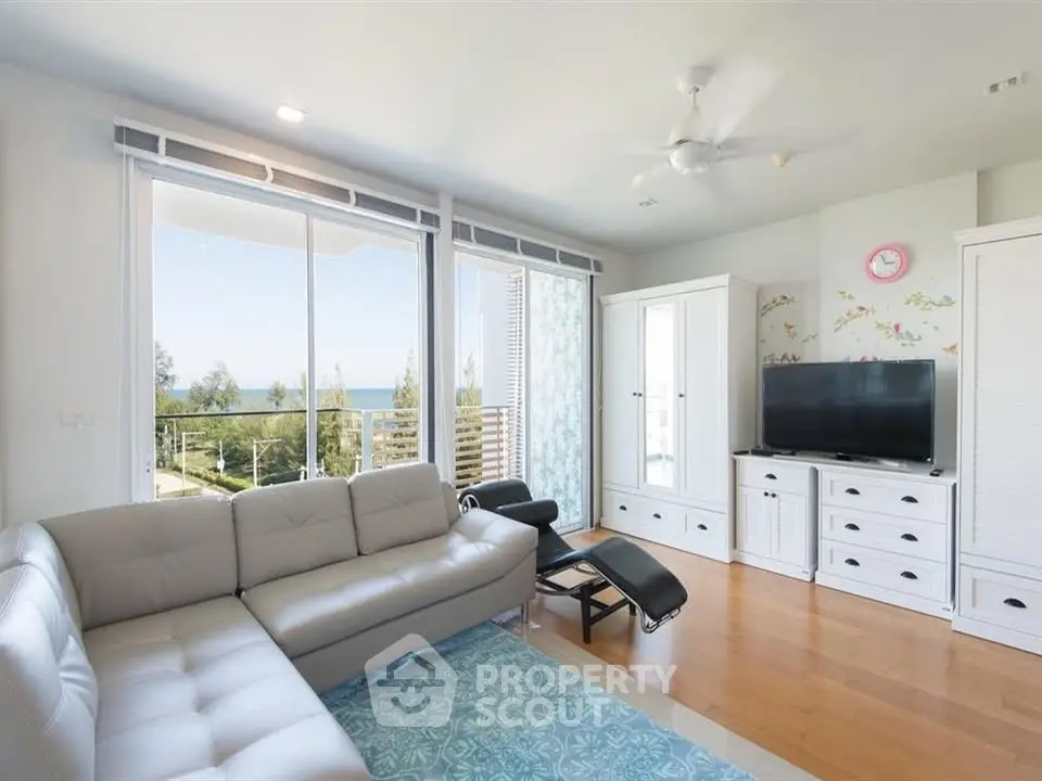 Spacious living room with modern furniture and stunning balcony view