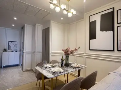 Elegant dining area with modern decor and stylish lighting in a contemporary apartment.