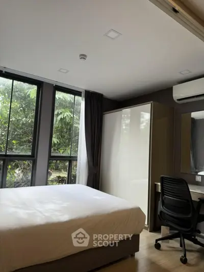 Modern bedroom with large windows and stylish furniture