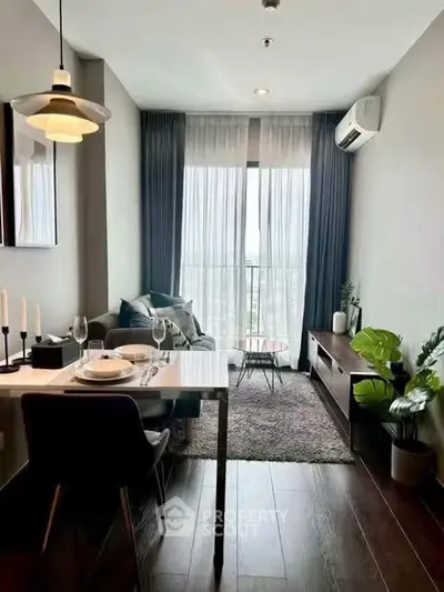 Modern living room with dining area, stylish decor, and large window view.