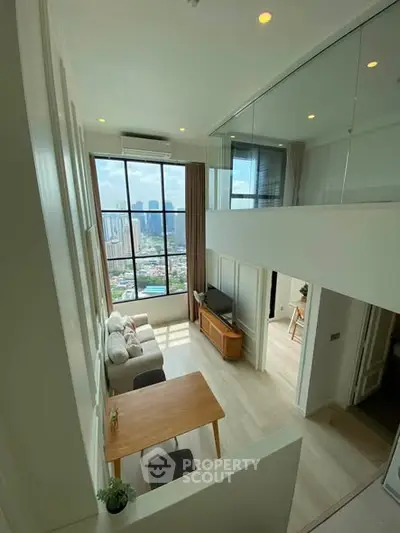 Stunning high-rise apartment with floor-to-ceiling windows and mezzanine, offering breathtaking city views.