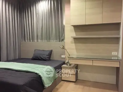 Modern bedroom with sleek design and built-in desk, perfect for urban living.