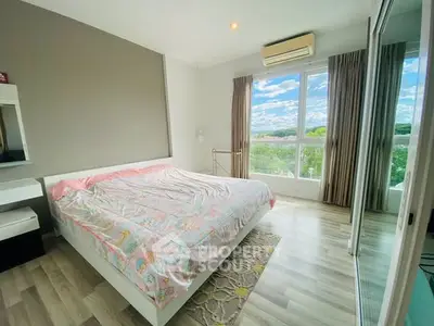 Bright bedroom with large windows and scenic view, featuring modern decor and ample natural light.