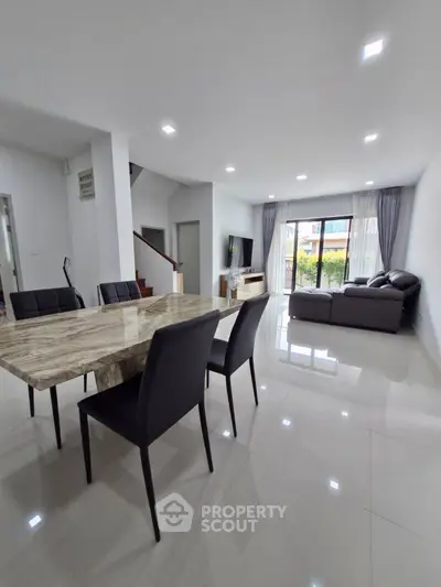 Spacious modern living room with elegant dining area and natural light