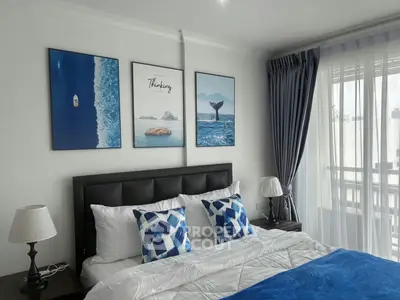 Elegant bedroom with modern decor, featuring a cozy bed, stylish artwork, and natural light from large windows.