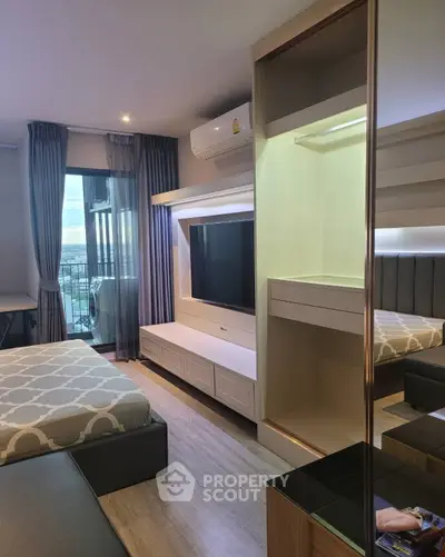 Modern bedroom with stylish decor and balcony view in a high-rise apartment.