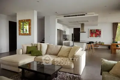 Spacious modern living room with open kitchen and stylish decor