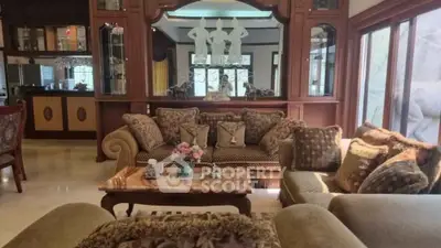 Luxurious living room with elegant decor and plush seating in a spacious home.