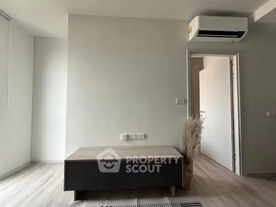 Modern minimalist living room with air conditioning and sleek furniture