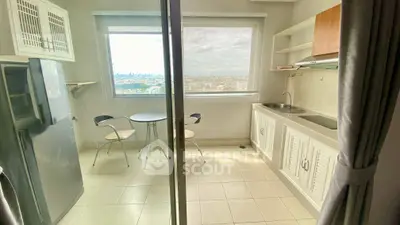 Bright kitchen with city view, compact dining area, and modern appliances.