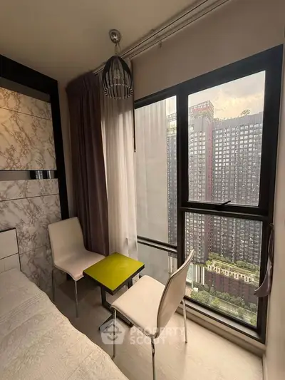 Modern bedroom with city view, featuring stylish decor and floor-to-ceiling windows.