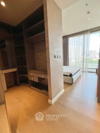 Spacious bedroom with walk-in closet and city view, featuring modern design and natural light.