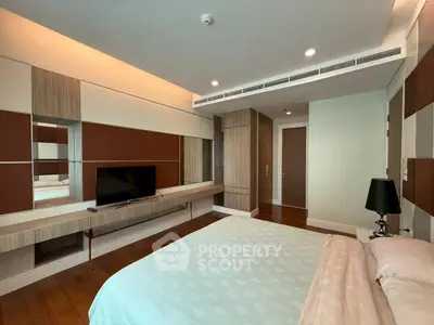 Modern bedroom with stylish decor and built-in TV unit