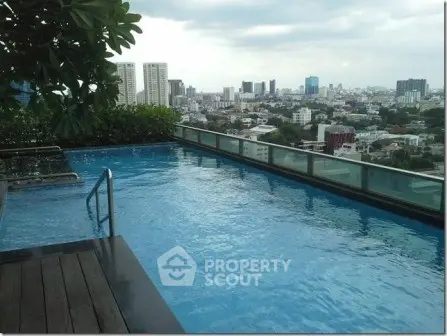Luxurious rooftop pool with stunning city skyline view, perfect for relaxation and leisure.