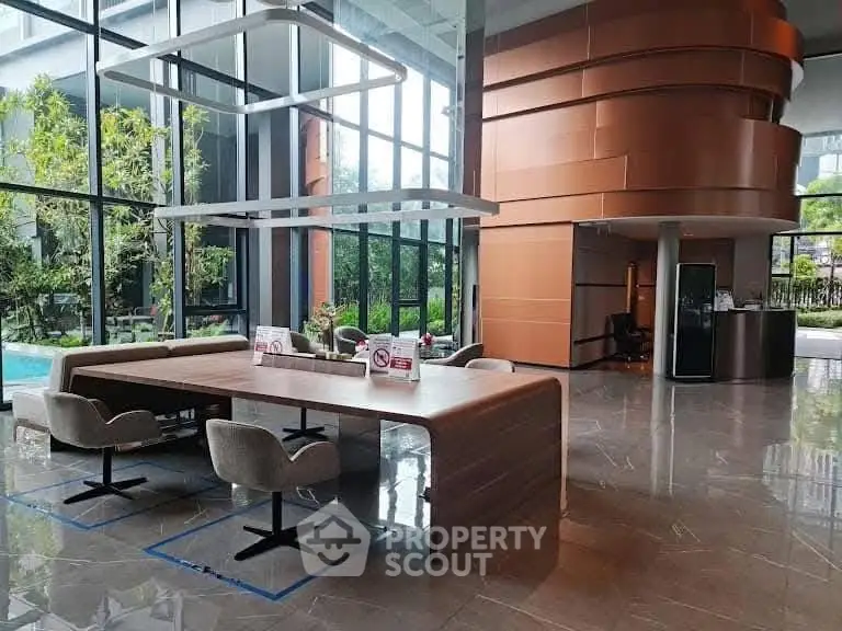 Modern building entrance with sleek design and pool view