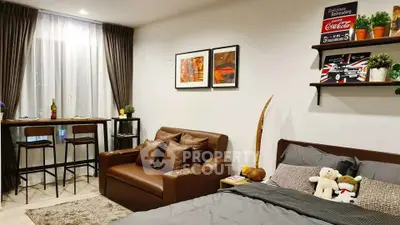 Cozy studio apartment with stylish decor and comfortable seating area