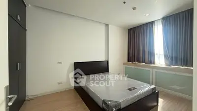 Spacious modern bedroom with natural light and sleek furnishings