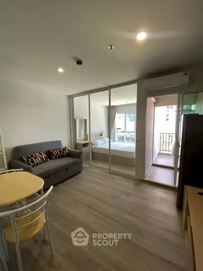 Modern open-plan living room with glass partition and balcony view