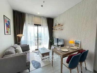 Modern living room with stylish decor and balcony view in a contemporary apartment.