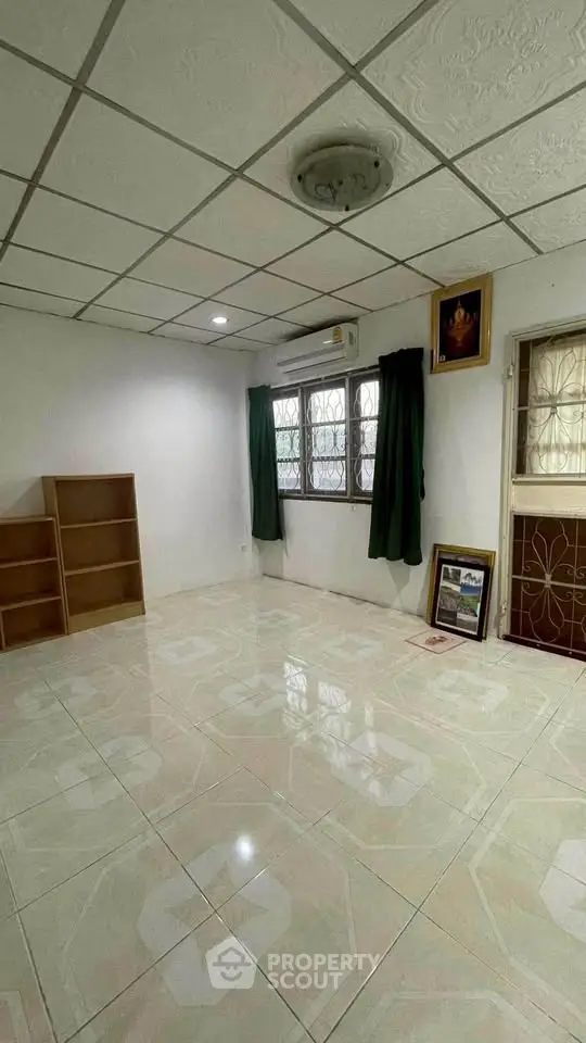 Spacious room with tiled floor and natural light, ideal for versatile use.