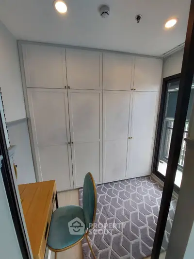 Modern study room with built-in cabinets and stylish chair