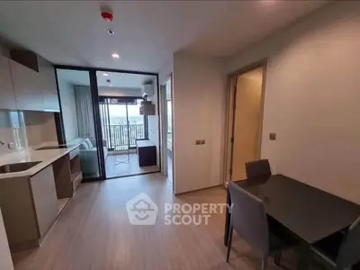 Modern apartment interior with open kitchen and balcony view