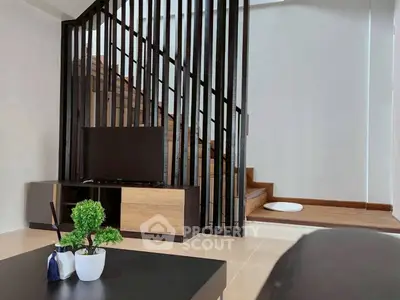 Modern living room with stylish staircase and sleek furniture design