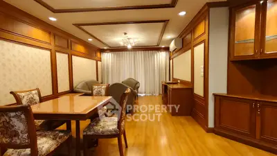 Luxurious living room with elegant wooden decor and plush seating in a high-end apartment.