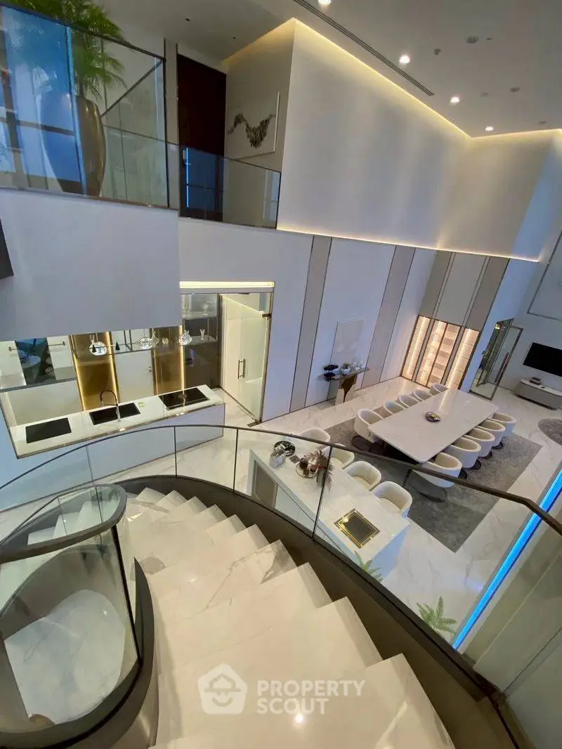 Luxurious modern living room with open kitchen and elegant staircase