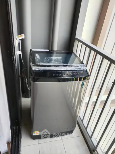 Modern washing machine on apartment balcony with sleek design