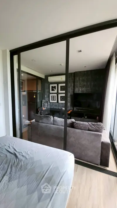 Modern living room with glass partition and stylish decor