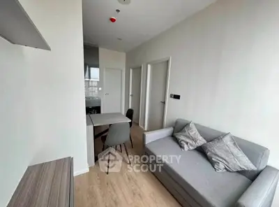 Modern living room with sleek furniture and wooden flooring in a contemporary apartment.