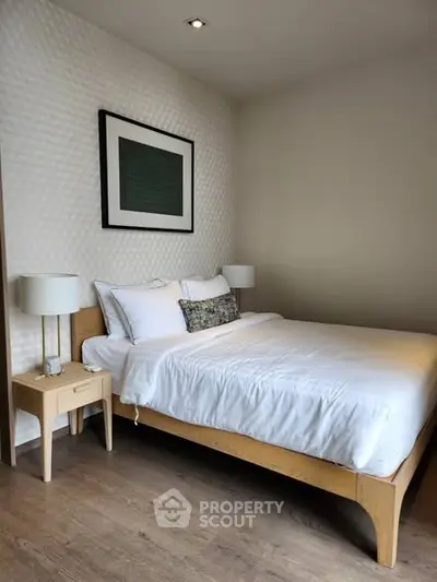 Cozy modern bedroom with stylish decor and wooden flooring