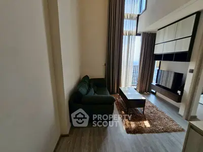 Spacious modern living room with high ceilings and large windows offering stunning views.