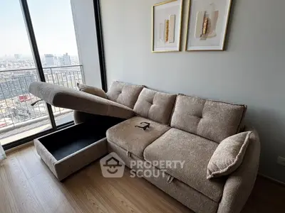 Modern living room with stylish sofa and city view balcony, perfect for urban living.
