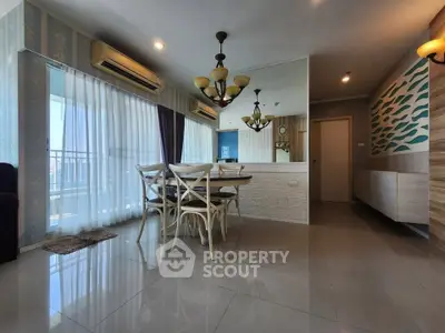 Spacious modern living room with elegant dining area and large windows offering city views.