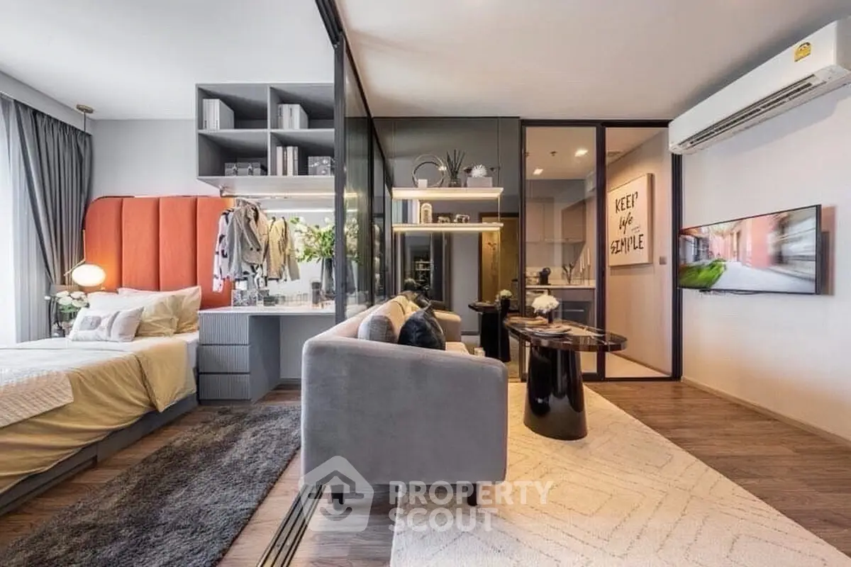 Modern studio apartment with stylish decor and open layout, featuring a cozy living area and elegant bedroom.