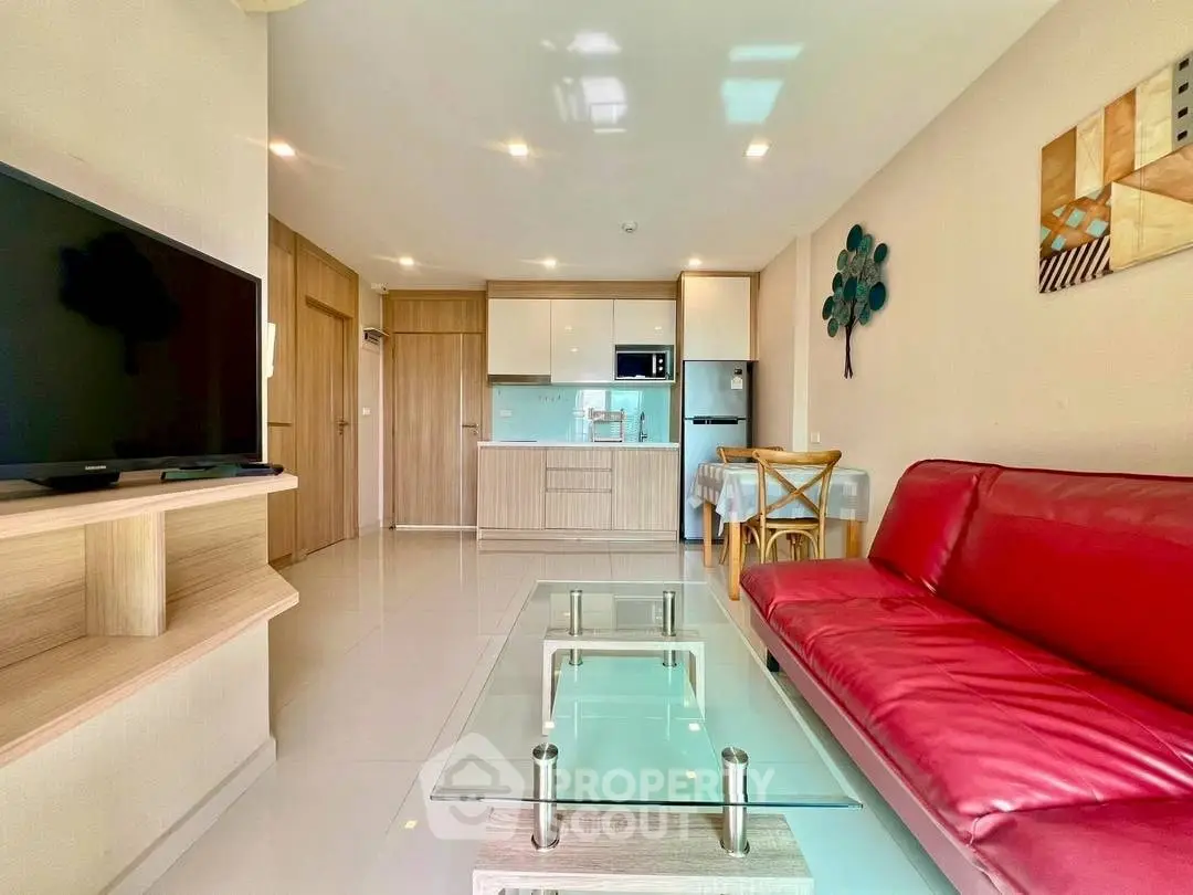 Modern living room with red sofa and open kitchen layout