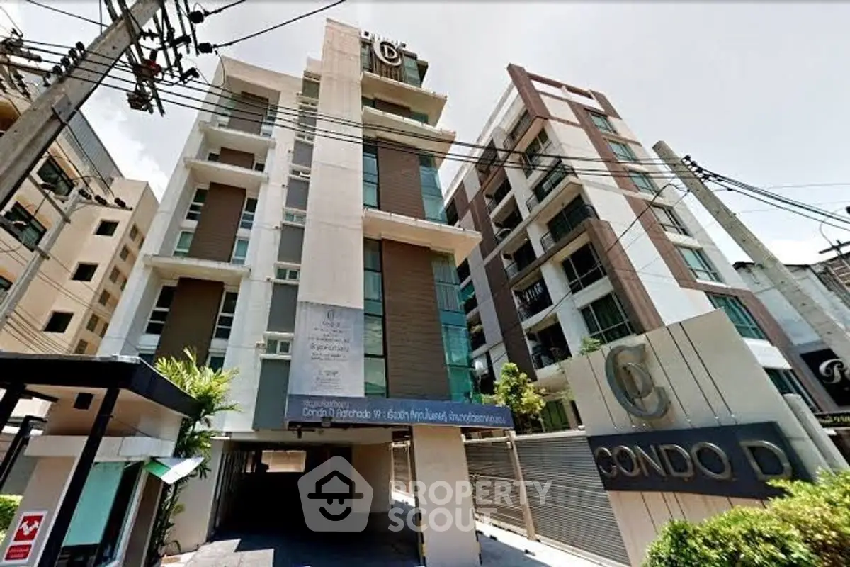 Modern condo building exterior with sleek design and urban appeal