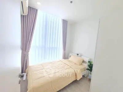 Bright and cozy bedroom with large window and modern decor