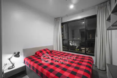 Modern bedroom with city view and stylish red checkered bedding
