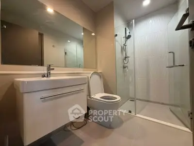 Modern bathroom with sleek fixtures and glass shower enclosure