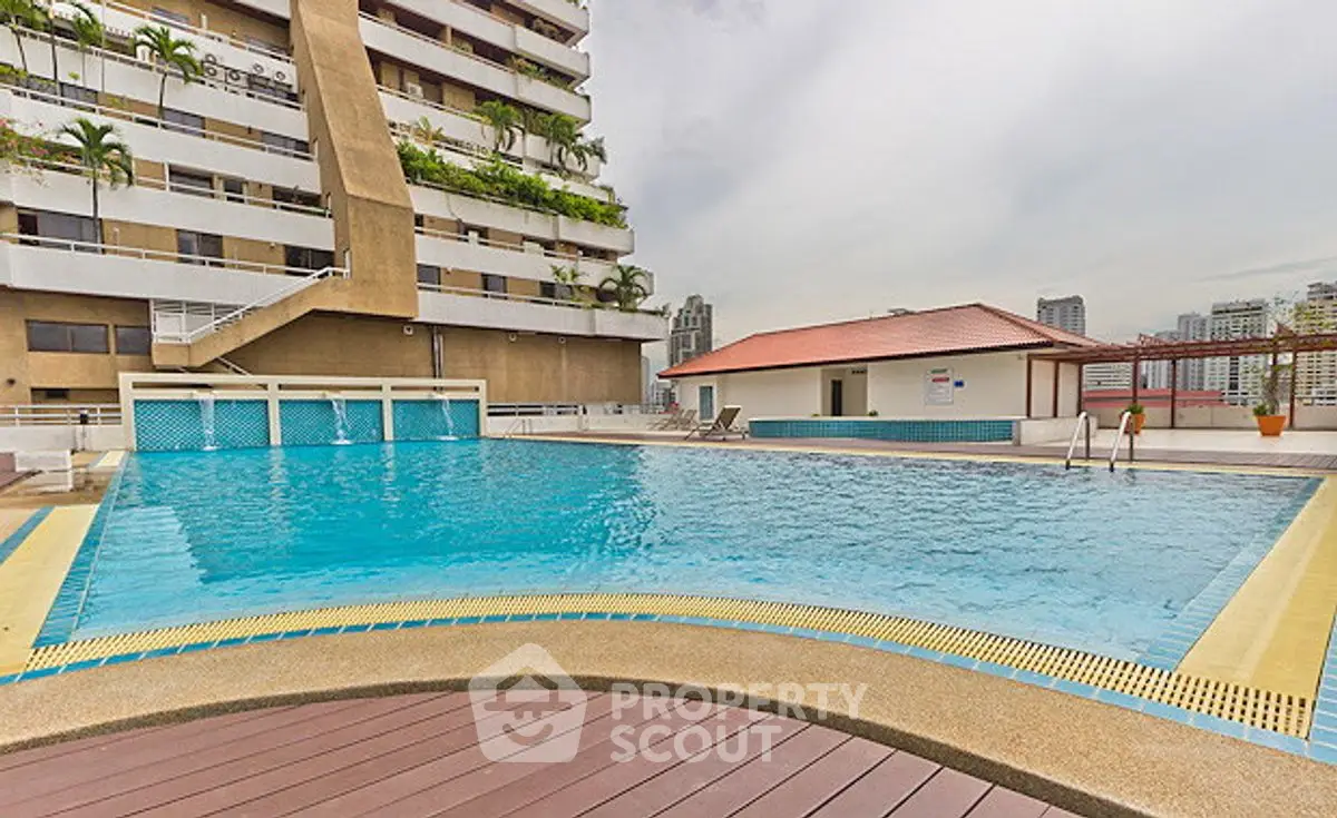 Luxurious rooftop pool with city views in a modern high-rise building.